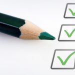 checklist with green checkmarks and pencil